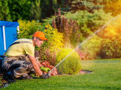 man installing a sprinkler system